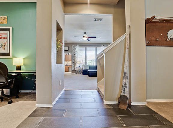 Entry to home with study on left, formal dining on right