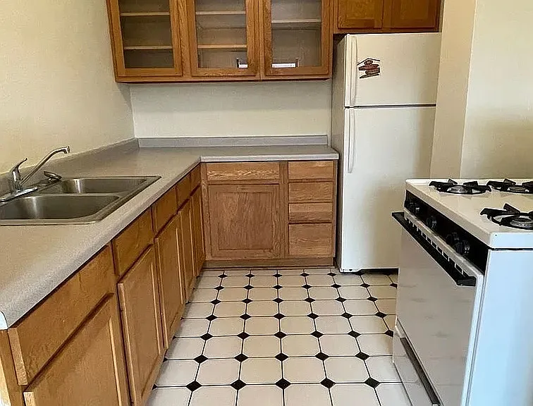 Upgrade your lifestyle at LS Capital Group with this inviting kitchen, featuring ample cabinetry and modern appliances. Enjoy the perfect blend of comfort and convenience. Your ideal home awaits; schedule a tour today!