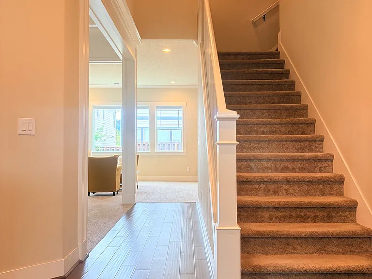 Entry view of the staircase and living area.