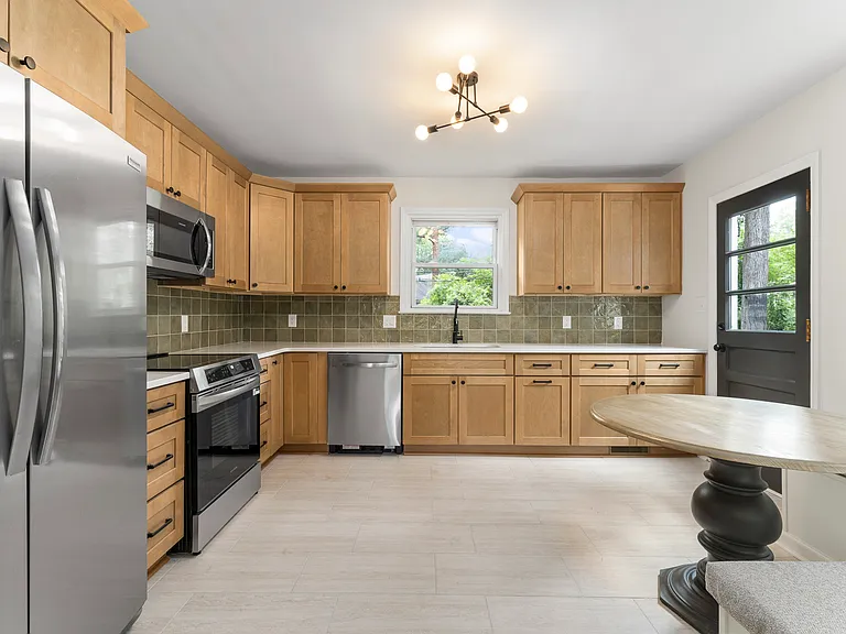 Kitchen features new cabinetry, all new stainless appliances and quartz counters. Stove top is induction.