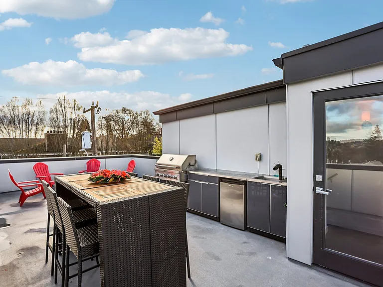 Huge roof-top deck with lake & mountain views includes a wet-bar, gas grill, and gas fire pit.