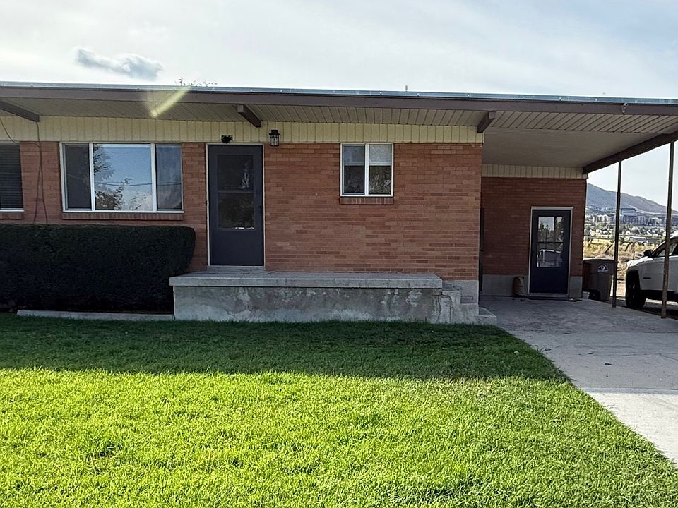 Large Duplex with private driveway, mudroom/laundry room and full unfinished basement for storage, carport.