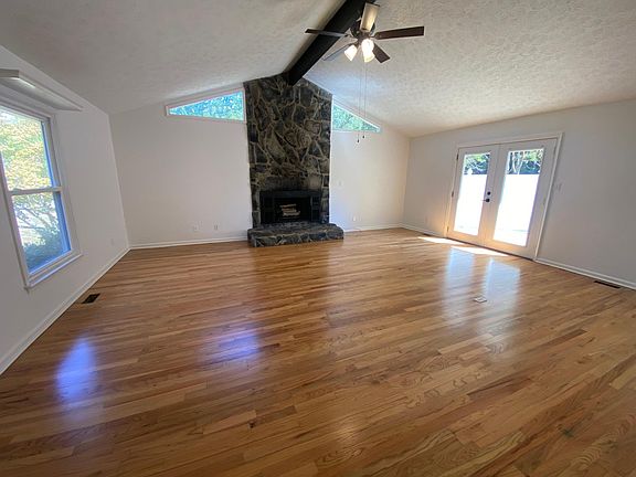 High ceilings, bright and spacious windows in family room with stone fireplace. French doors open into a enclosed patio. Newly refinished hardwood floors throughout the entire home.