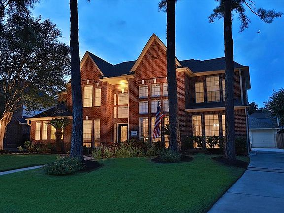 Three car garage and long driveway for parking.