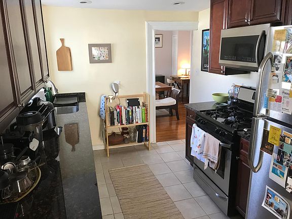 Kitchen with dishwasher, gas range and microwave, stainless steel refrigerator