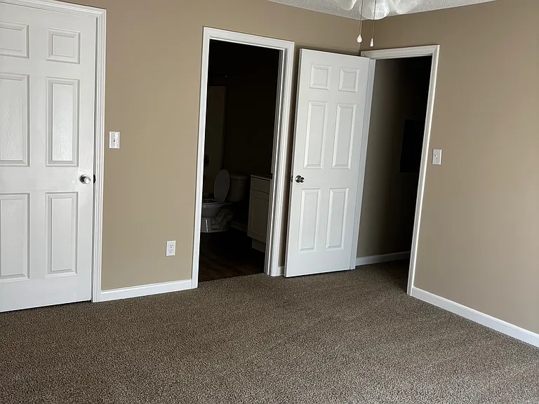 Primary bedroom with in-suite bathroom and walk-in closet.