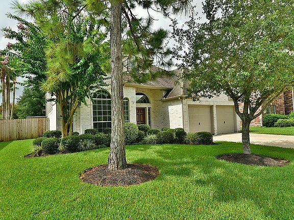 The front yard of this home is beautifully landscaped and offers curb appeal! Note the mature shade trees and inviting front entry.