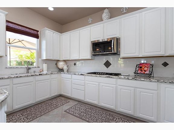 Beautiful contemporary kitchen with LG refrigerator, microwave, double ovens and a bar area to mix your favorite drinks. Ready for your personal touches