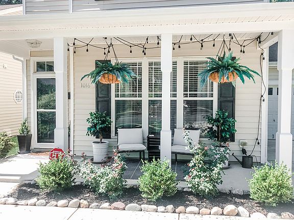 Cozy front porch with ample room for seating and string market lights for the evenings.
