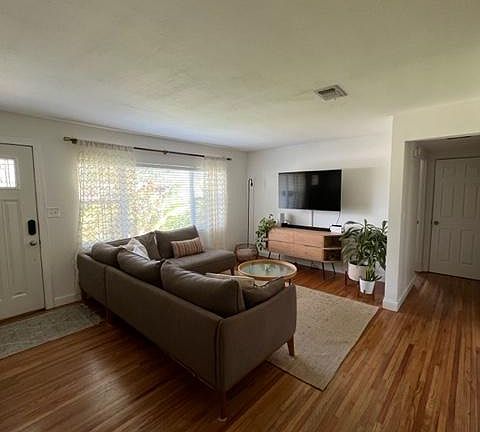Living room with large front windows.