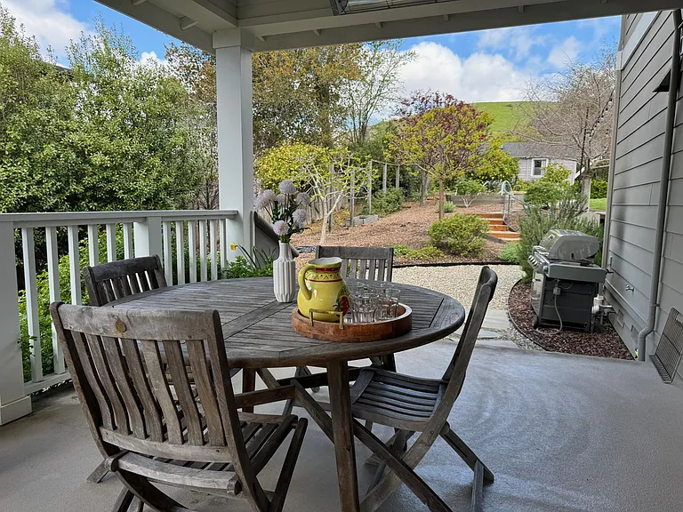Heated dining area on side covered porch (gas grill in background)
