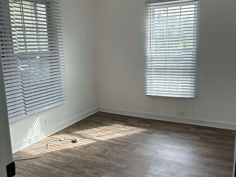 Front bedroom (no furniture). 2 inch blinds throughout with luxury plank flooring.