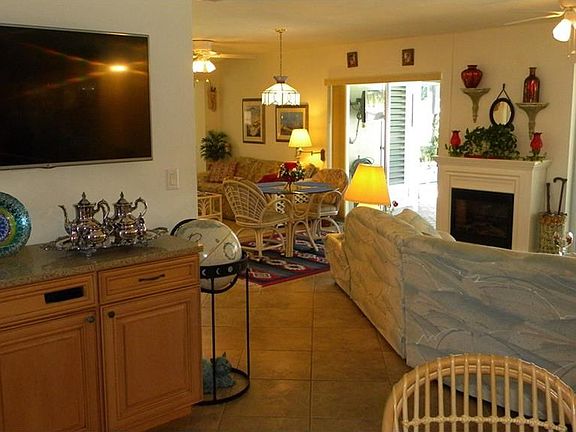 Another view from the kitchen, showing 1 of several large screen TV's.   Great Room & another TV area is to the left.