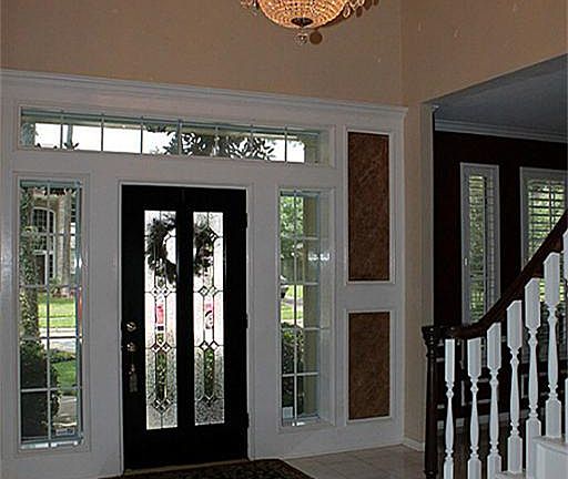 Dramatic 2-story Entry & sparkling crystal chandelier greet you upon entering through the leaded glass front door