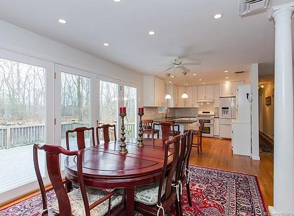Dining room with fan and column and recessed lights
