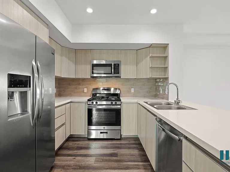 Large-Size Kitchen with Stainless-Steel Refrigerator, Stove, Microwave Oven, and Dishwasher