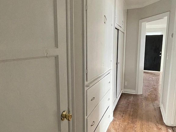 Hallway with build-in drawer space and full wall closet and long with washer & dryer hook-up