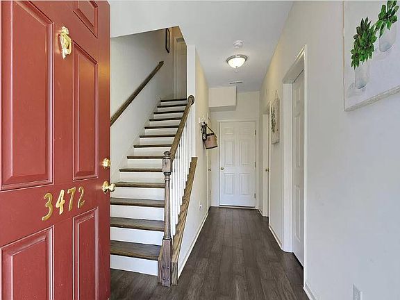 Front Entrance with view of doors to room, bathroom & garage
