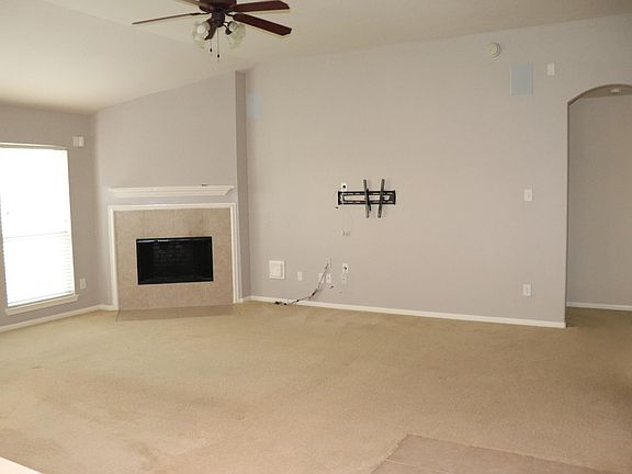 Large open living room. In-wall speakers for surround sound.