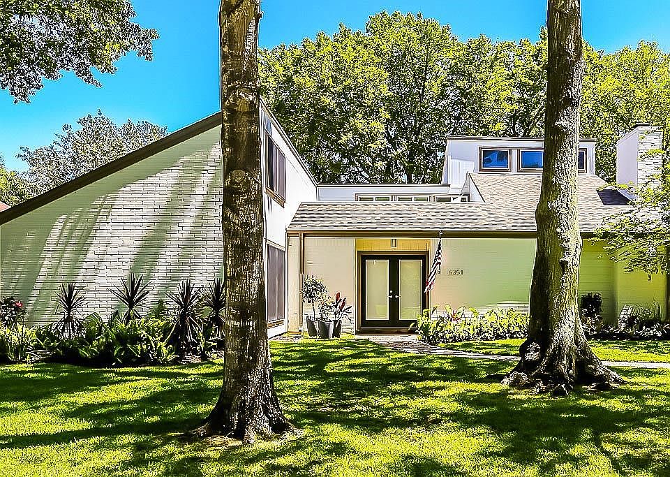 Mid-century architecture is stunning nestled on a wooded lot in Brook Forest.