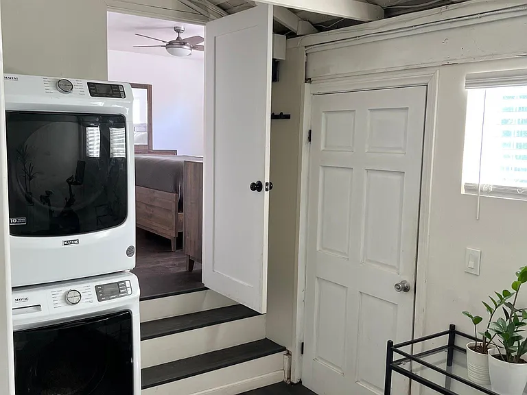 Bonus room view of brand new washer and dryer, bedroom 2 and door to driveway
