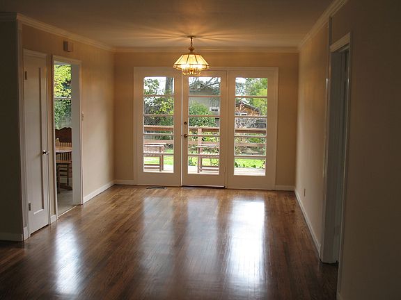 Dining Area with French Doors Leading to Deck Overlooking Fenced In Yard