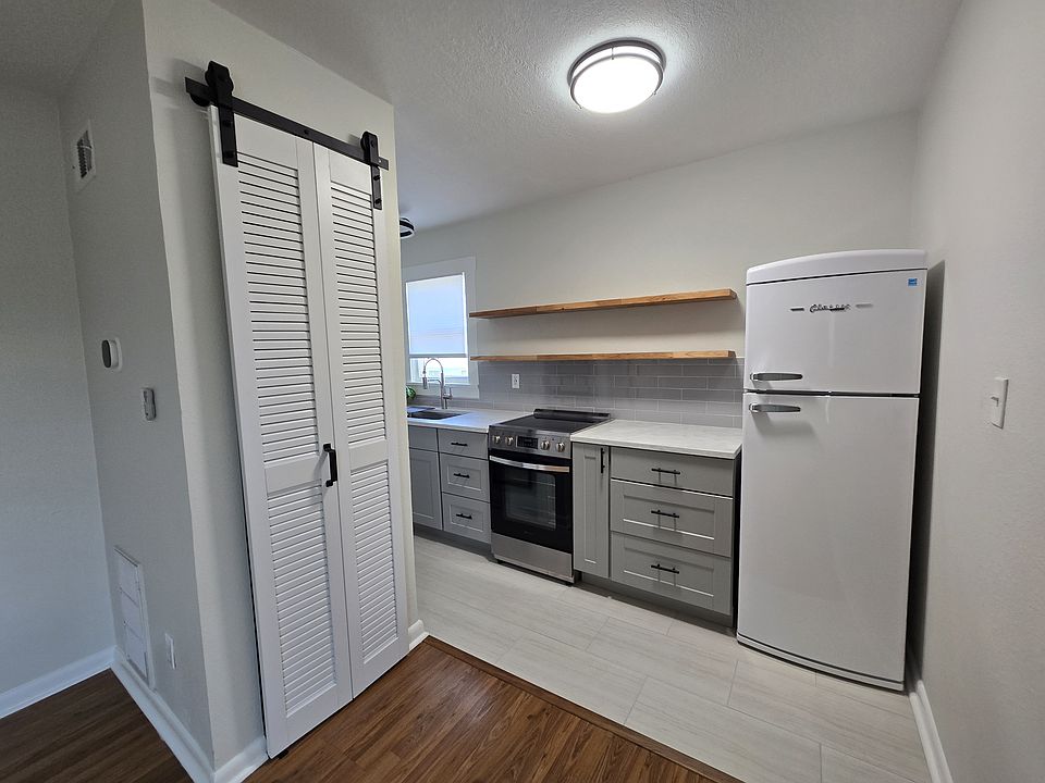 View of kitchen from main living area, closet houses HVAC