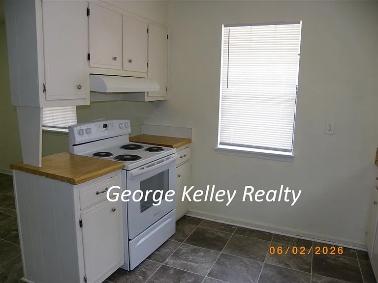 Kitchen with new electric range and new window blind and New vinyl flooring