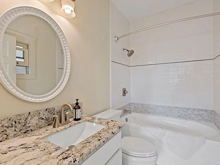 The updated master bathroom with tub and shower