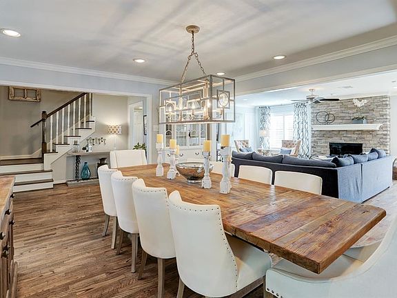 The dining room seamlessly flows into the open living and entry. Recessed cans, hardwood floors, crown molding, encased openings and natural light