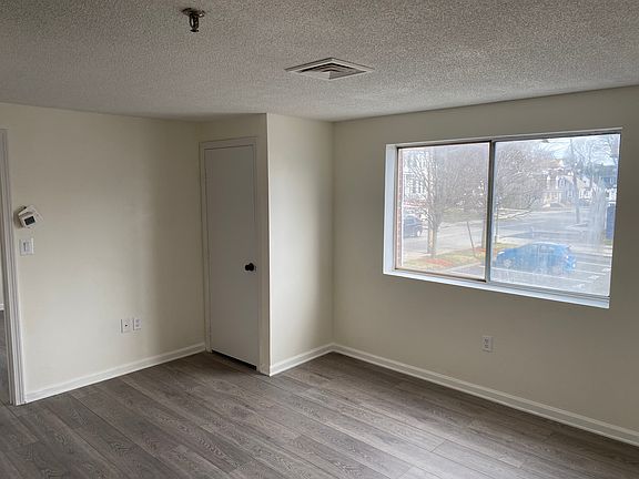 Spacious living room with lots of sun and view of the entry door and your designated parking space.