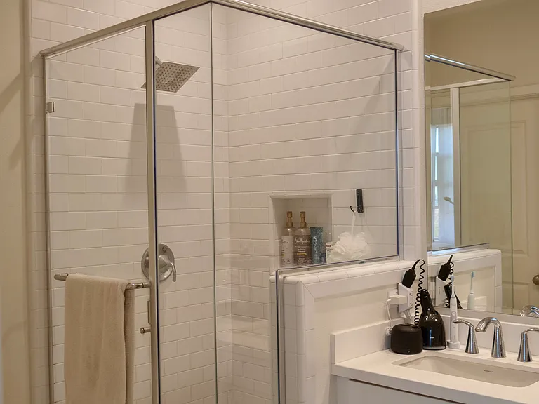 Primary Bathroom: Features a modern, spacious walk-in standing shower.