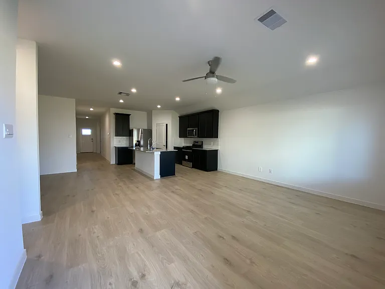 Open kitchen and living room, part of dining room visible on left side (view from backdoor)