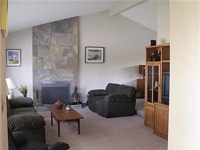 From the hardwood entry way step down into the living room with slate fireplac