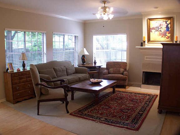 15x19 Den with a fireplace, nice windows that look out into the backyard