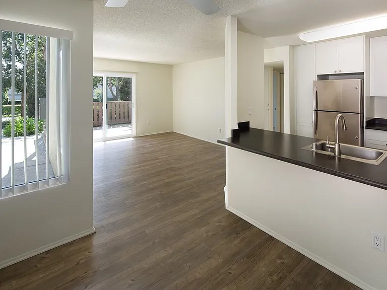 Renovated Package I kitchen, dining, and living area with hard-surface flooring