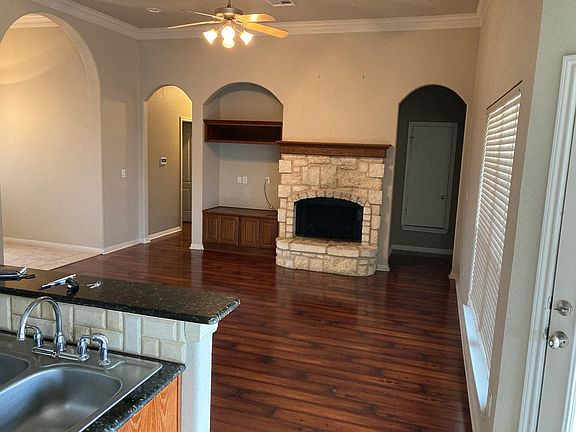 Living room from kitchen. Master suite to the right, additional 3 bedrooms and 1 bath to the left.