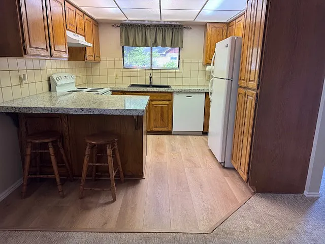 Kitchen with new flooring and granite countertops. New appliances.