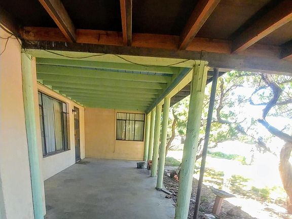 front porch looking south from one car carport and garage to the east