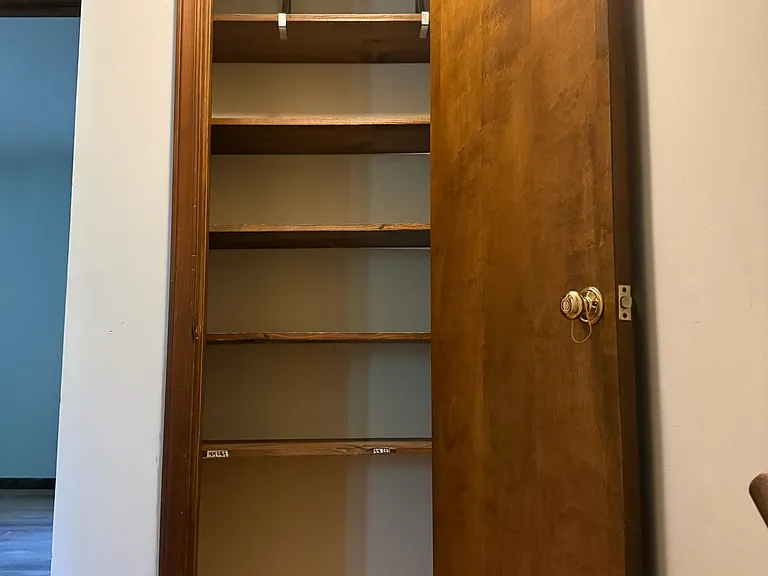 upstairs storage closet near the top of the stairs.