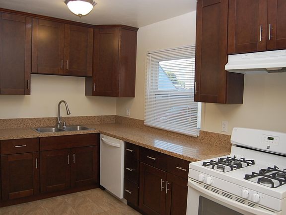 Remodeled kitchen includes refrigerator, and new microwave.