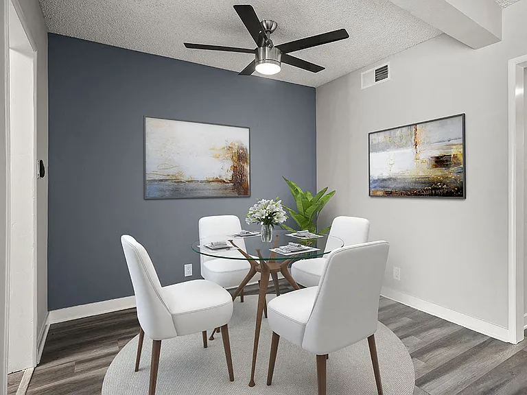 Hardwood floored dining area with celling fan.