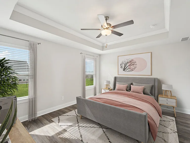 Primary bedroom with king size bed and large window.