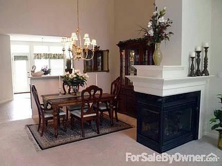 Dining Room
						:
						The dining room is located next to the three-sided fireplace.