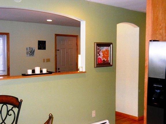 Archway Opens to Dining Area and Kitchen