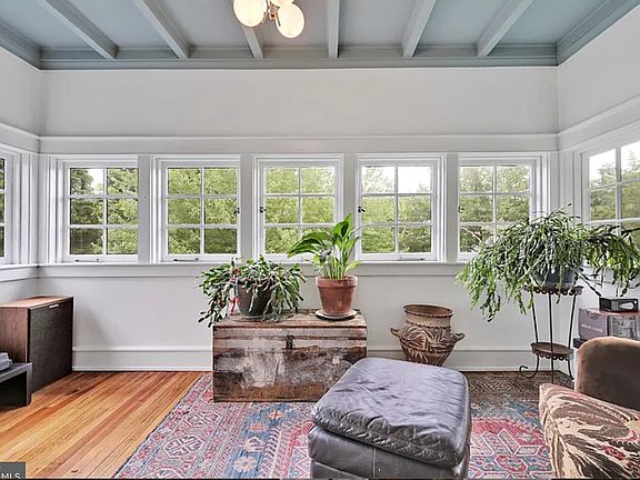 Sunroom off living room, perfect for home office and/or cozy lounge area.