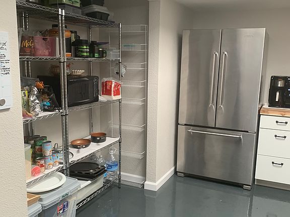 Kitchen, lots of light, pantry with metal shelves.