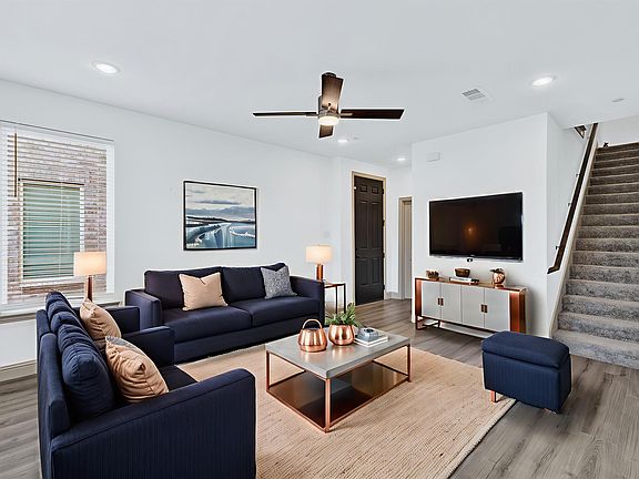 Living room featuring open floor plan, wood style floors, recessed lighting, and ceiling fan - virtually staged