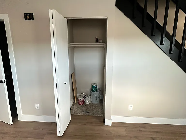 Inside storage under the stairs in the living room.