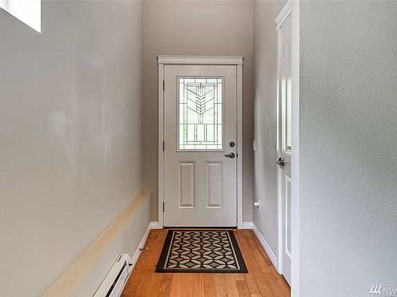 Hardwood entry and front door with leaded glass.